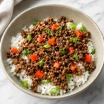 Easy Beef Rice Bowls with saucy beef, red bell pepper, and sesame seeds over fluffy rice